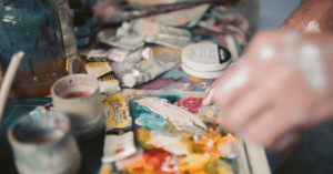 Pessoa adulta realizando pintura como prática terapêutica para alívio da ansiedade.